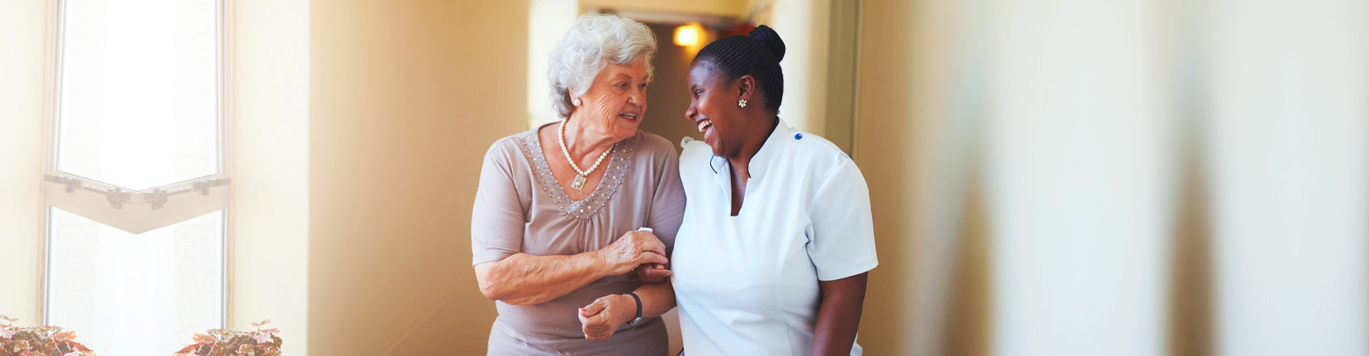 caregiver and an elderly woman chatting