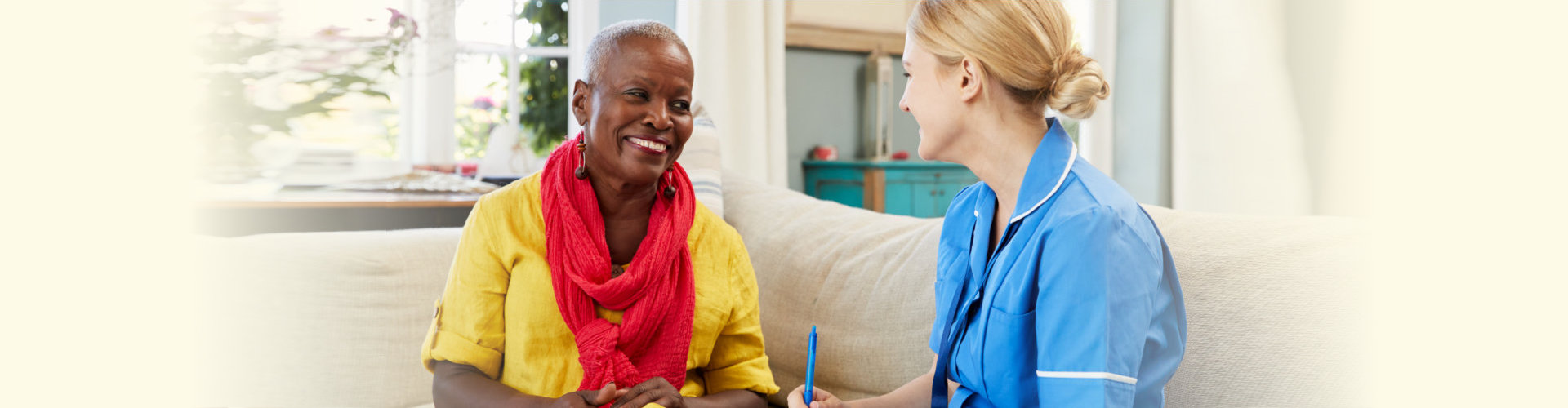 caregiver and an elderly woman chatting