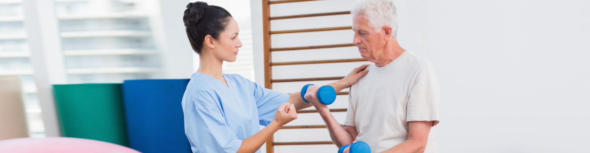caregiver and old man doing exercise